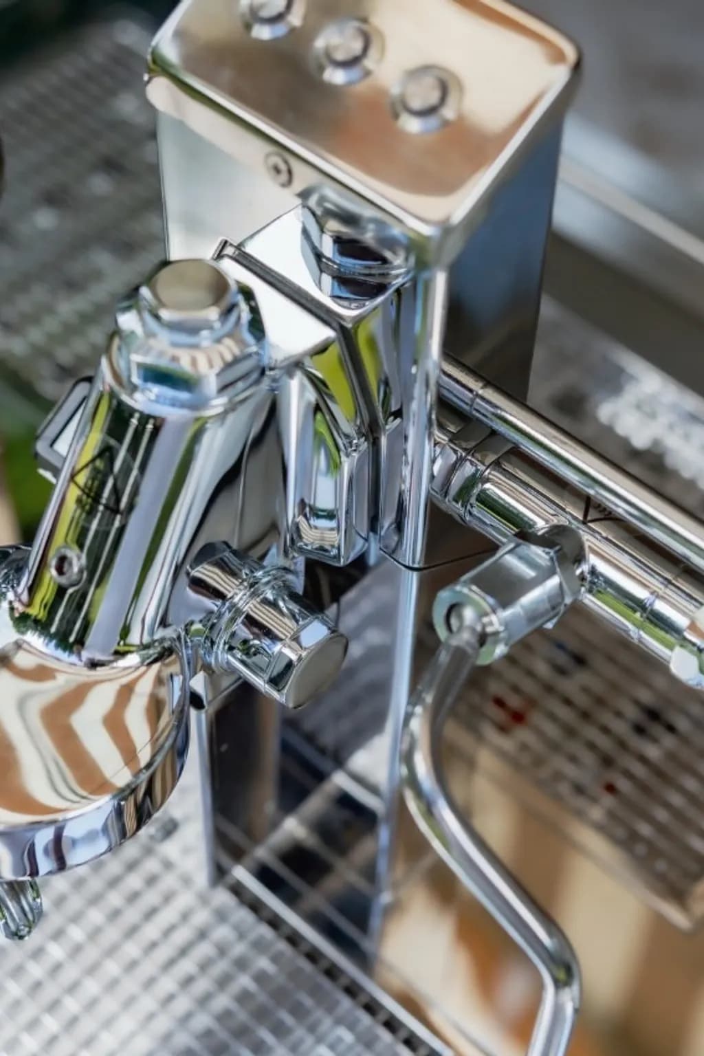 White coffee cart with a grinder and espresso machine in a garden setting